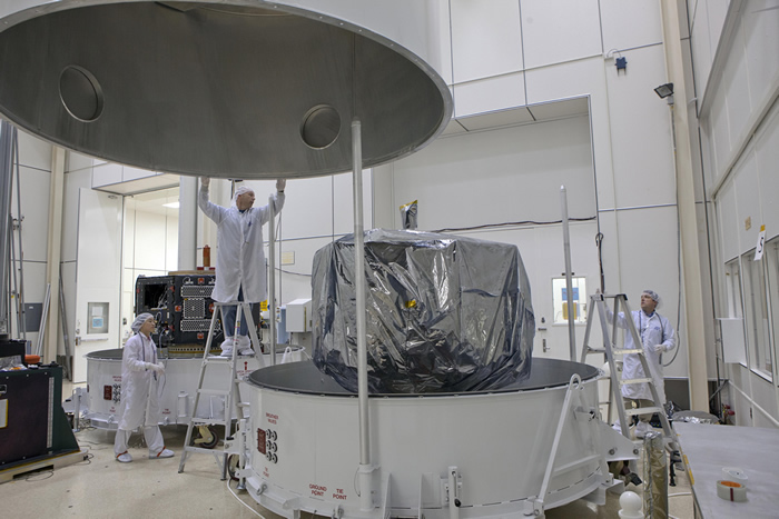 Both spacecraft shown in the bases of their individual custom-built shipping containers; 